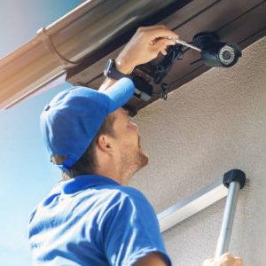 man install outdoor surveillance ip camera for home security man install outdoor surveillance ip camera for home security