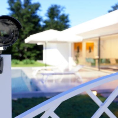 Exterior Of A Villa With Security Camera At The Entrance Of The Garden.